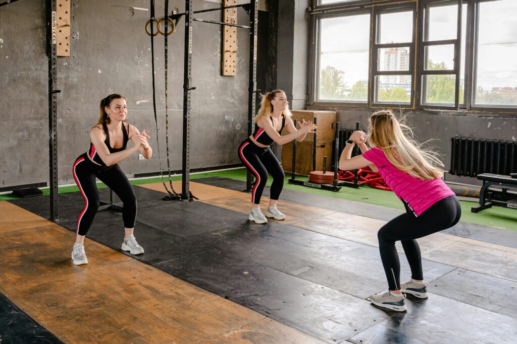 Woman doing squats as part of morning exercises at home to tone legs and improve fitness